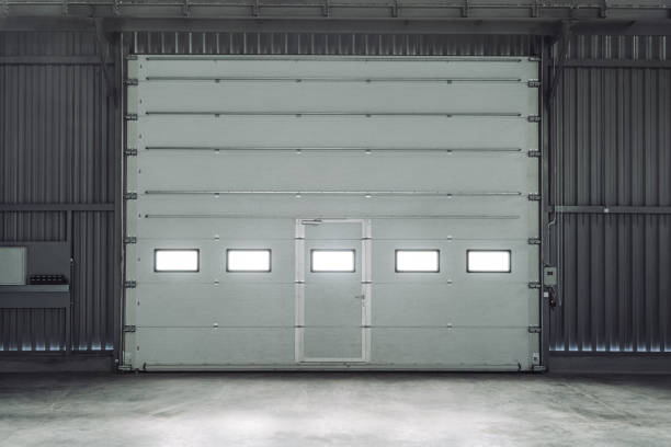 Overhead sectional door in a large industrial building. Lift gate. Inside view.