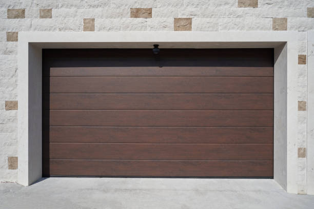 Modern and wide brown garage door. Automatic garage door.